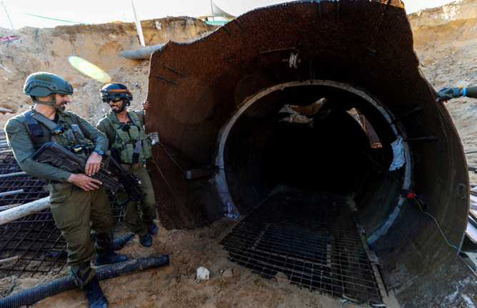Israeli soldiers are seen near the opening of an iron-girded tunnel designed by Hamas to disgorge carloads of Palestinian fighters